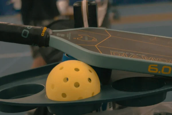 The Wembley Club pickleball paddle and ball on a court
