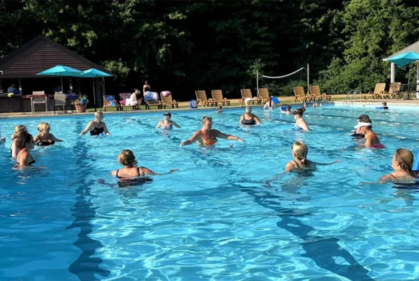 Adults taking a water fitness class in the outdoor pool at The Wembley Club in Chagrin Falls
